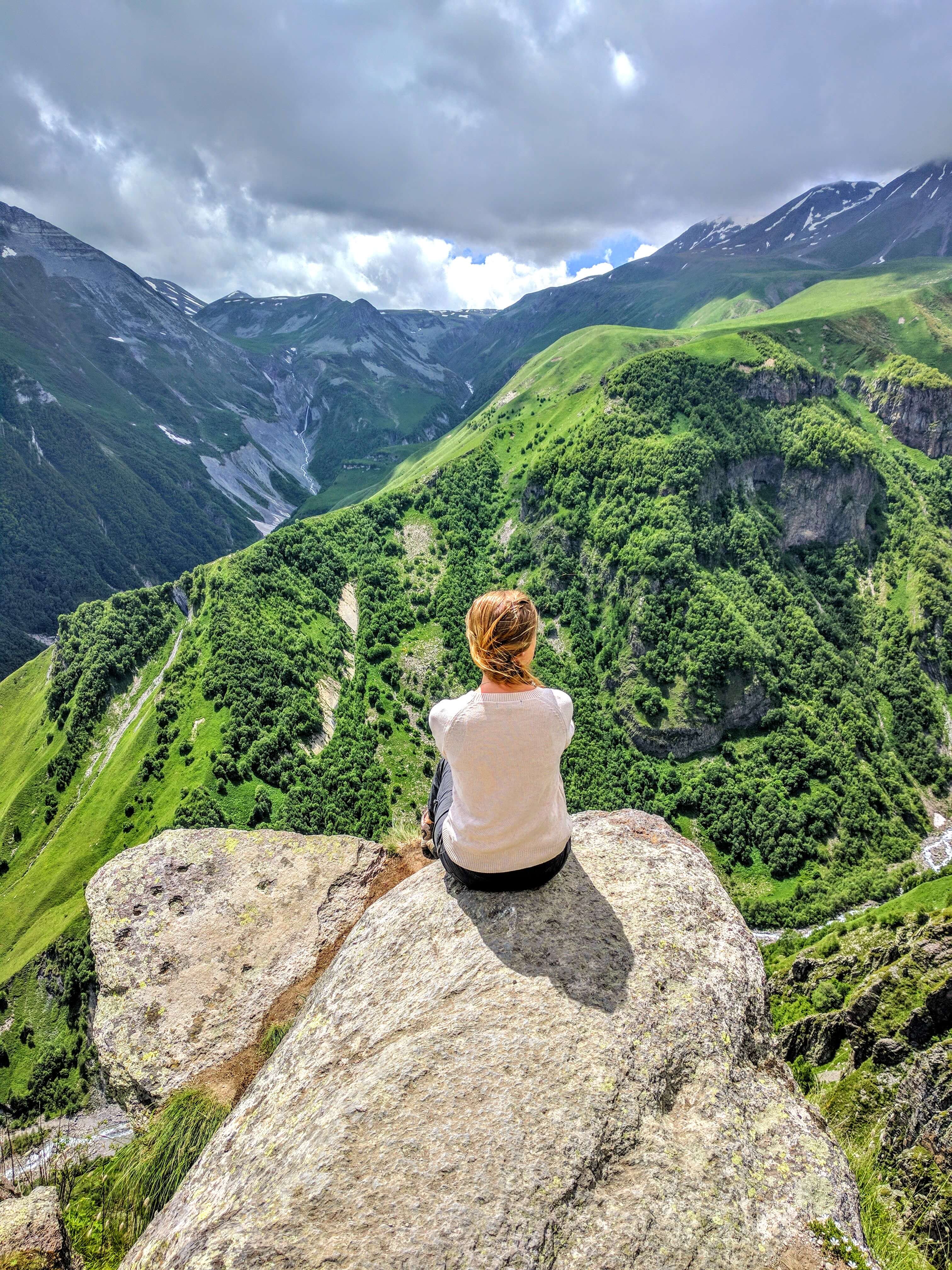 Hiker looking out over high-altitude Caucasian peaks